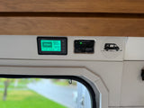 RV rental interior featuring a Renogy battery monitor at 98% charge and an active RV propane gas detector.