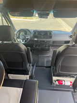 Spacious Mercedes-Benz Sprinter RV rental interior, featuring a detailed cockpit, dashboard, and fire extinguisher.