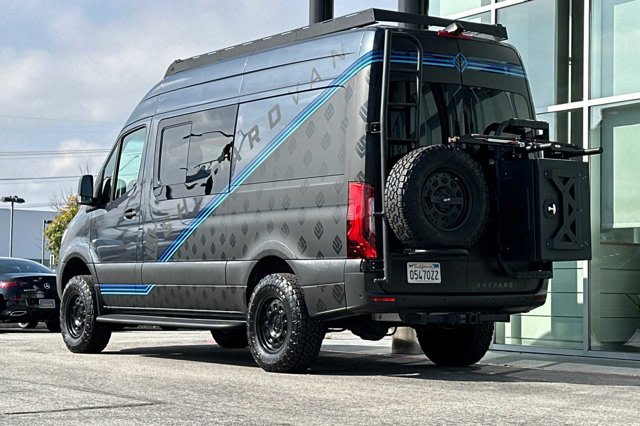  desert landscape.|Dark gray Mercedes Sprinter adventure van — photo 1