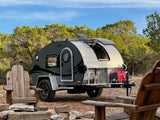 Experience camping with this modern RV rental teardrop trailer, complete with a generator, chairs, and fire pit.