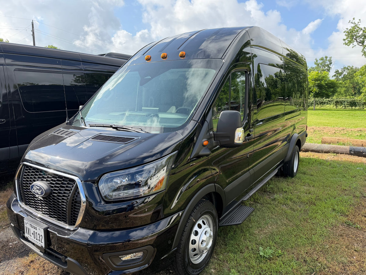  and infotainment screen.|Black Ford Transit van for RV rental — photo 8