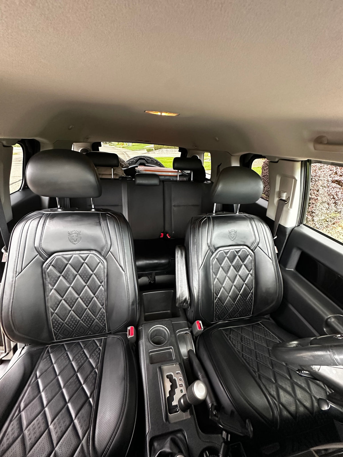 Interior of a vehicle shows black, quilted leather front seats & center console. Ideal for your next rv rental trip. — photo 11