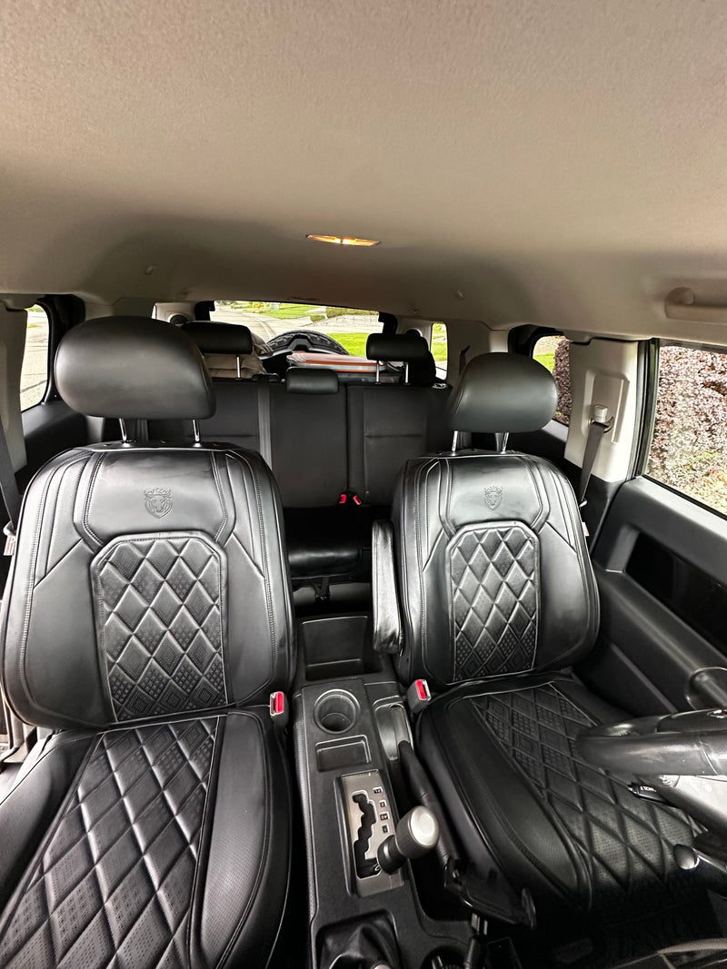 Interior of a vehicle shows black, quilted leather front seats & center console. Ideal for your next rv rental trip. — photo 11