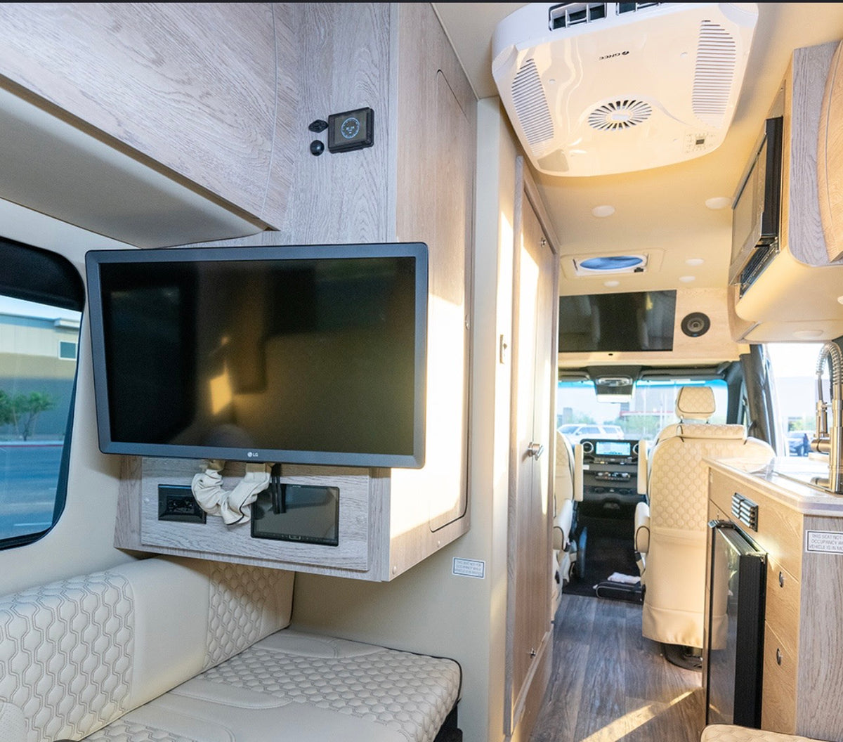  parked outside on a sunny day.|Sleek silver rv rental van — photo 3