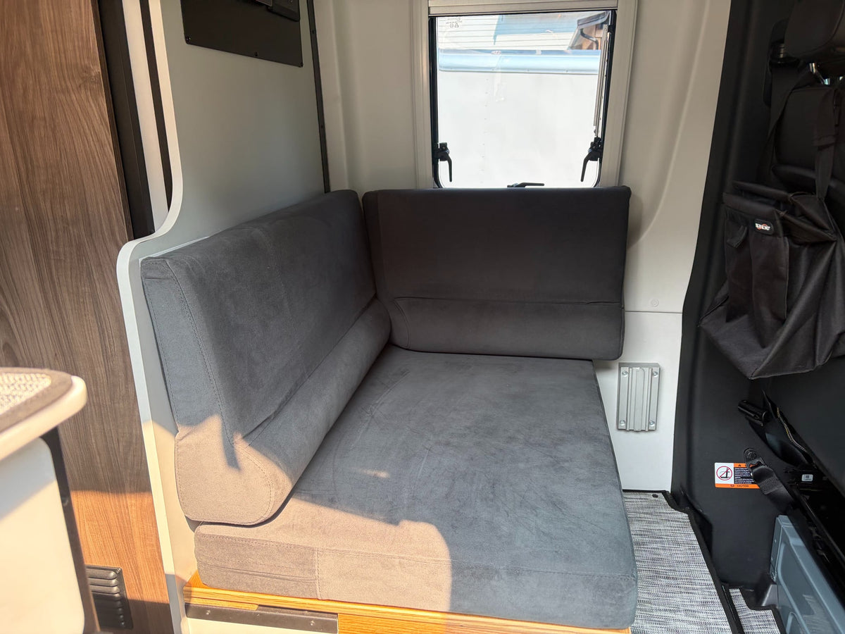  ready for your next rv rental journey.|This RV rental camper van showcases an extended awning & open side door revealing a compact kitchenette and pull-out counter.|Adventure-ready custom Sprinter van — photo 15