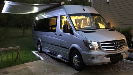  showing interior.|Silver Mercedes-Benz Sprinter RV rental parked at night