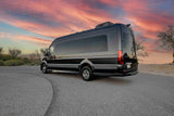Luxury black Mercedes-Benz Sprinter travel van, ideal for rv rental. Parked under a vibrant sunset sky.