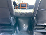 RV rental interior: A Luno air mattress and support create a bed between the front seats, ideal for travel comfort.