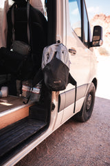 RV rental packed for the road: Gossamer Gear backpack, travel bags, and Crystal Geyser water bottles ready for exploration.
