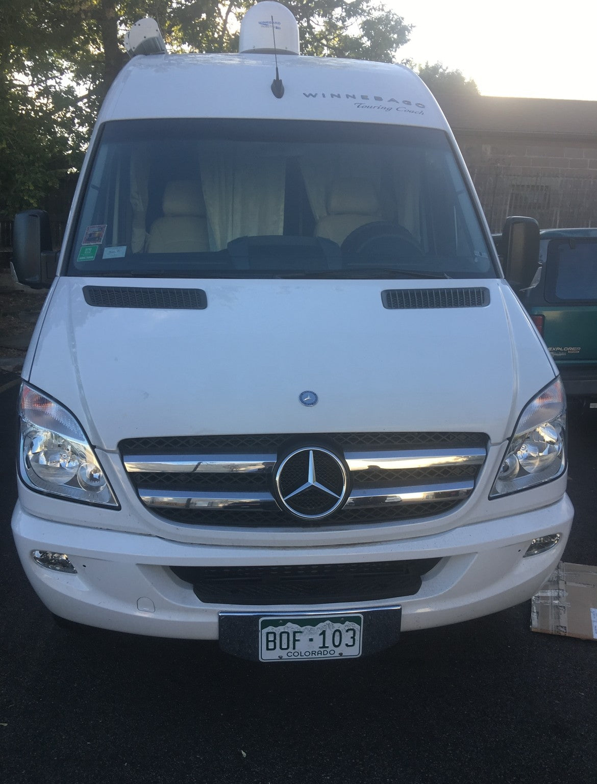 White Mercedes-Benz Sprinter Winnebago Touring Coach RV rental, front view, Colorado plates. — photo 3