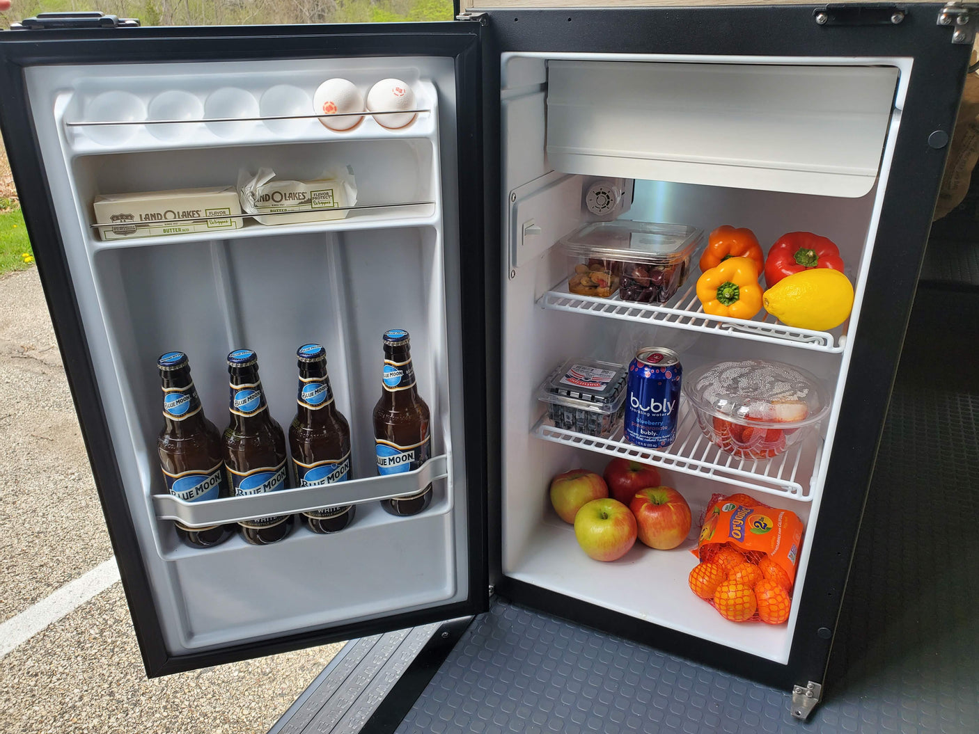 Stocked rv rental fridge with eggs, butter, beer, bubly, bell peppers, fruits, and berries ready for a trip!