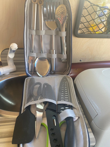 RV rental ready: compact kitchen featuring neatly packed cooking utensils, a knife, spatula, and sink for travelers.
