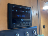 Furrion RV entertainment system, ideal for an rv rental, displays FM 87.5 with AUX, USB, and HDMI ports visible.