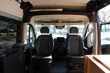 RV rental: Inside view of the front cabin with black driver & passenger seats, dashboard, and open side door.