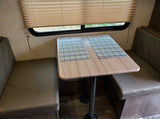 RV rental dinette: a cozy dining area with a table, bench seats, and two placemats, ready for use.