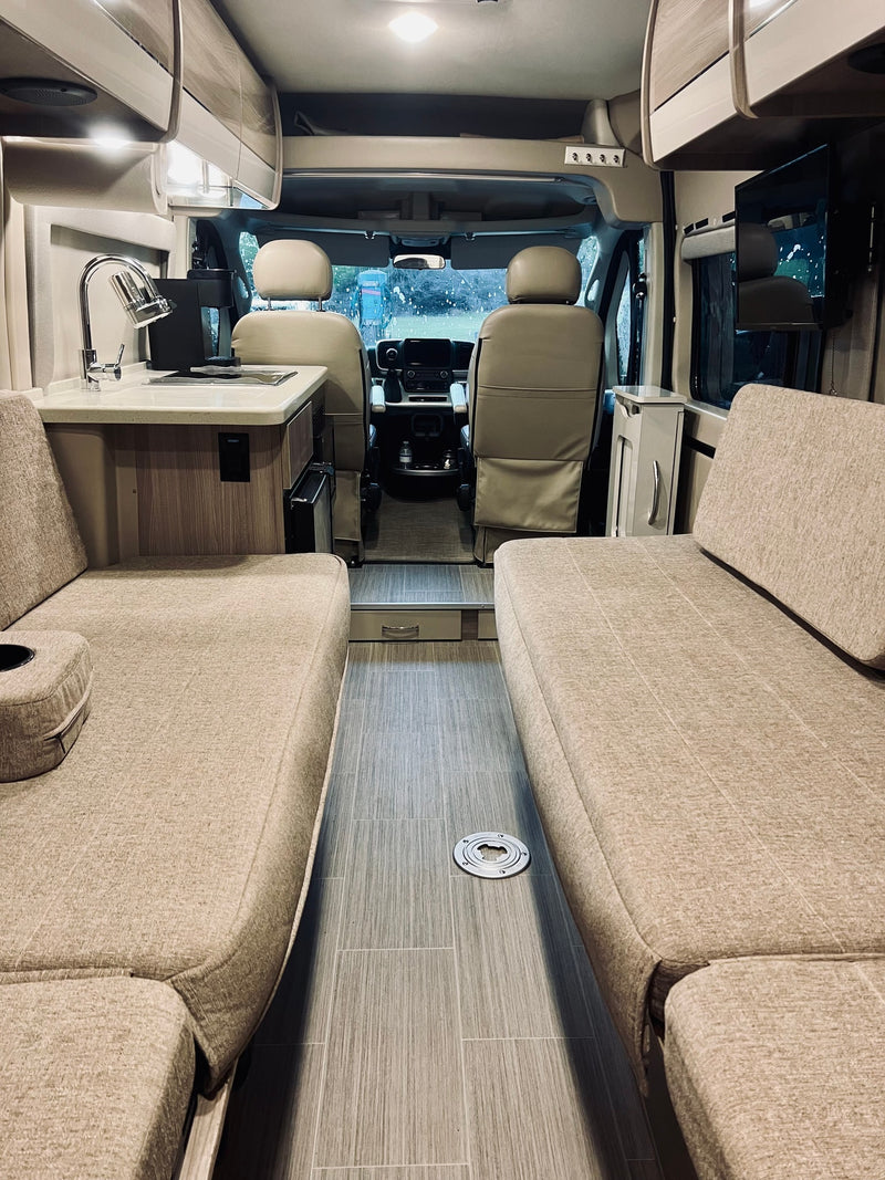  next to a microwave in a clean RV rental kitchenette.|RV rental's stainless steel microwave with its door open — photo 17