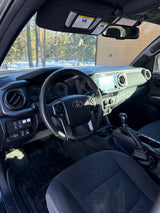 Toyota Tacoma interior with custom switches and WeatherTech mats. Ideal vehicle for your RV rental road trip.