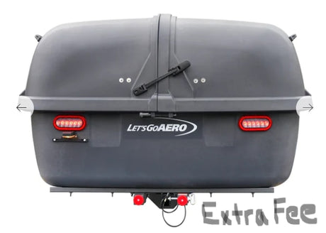 Rear view of a dark gray LET'S GO AERO cargo carrier, an essential RV rental accessory for extra gear.