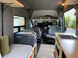 Inside a comfy RV rental: view of bed, Dometic fridge, kitchen sink, and front cabin. Perfect for van adventures.