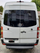 Back of white Mercedes Sprinter van for RV rental. Shows rear doors, tinted windows, and tow hitch, perfect for camper travel.