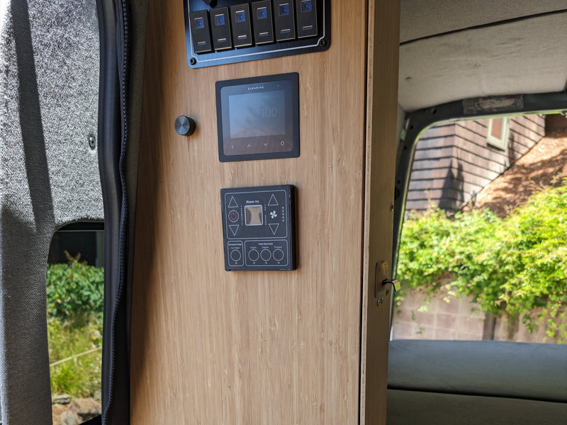  with nature outside.|RV rental camper van interior with black passenger seating — photo 10