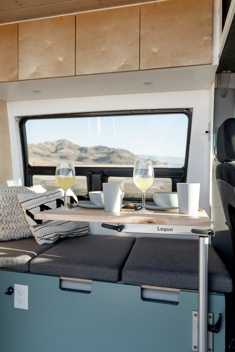 Enjoy the scenic view from this cozy camper van dining area, perfect for your next rv rental adventure. Features a Lagun table.