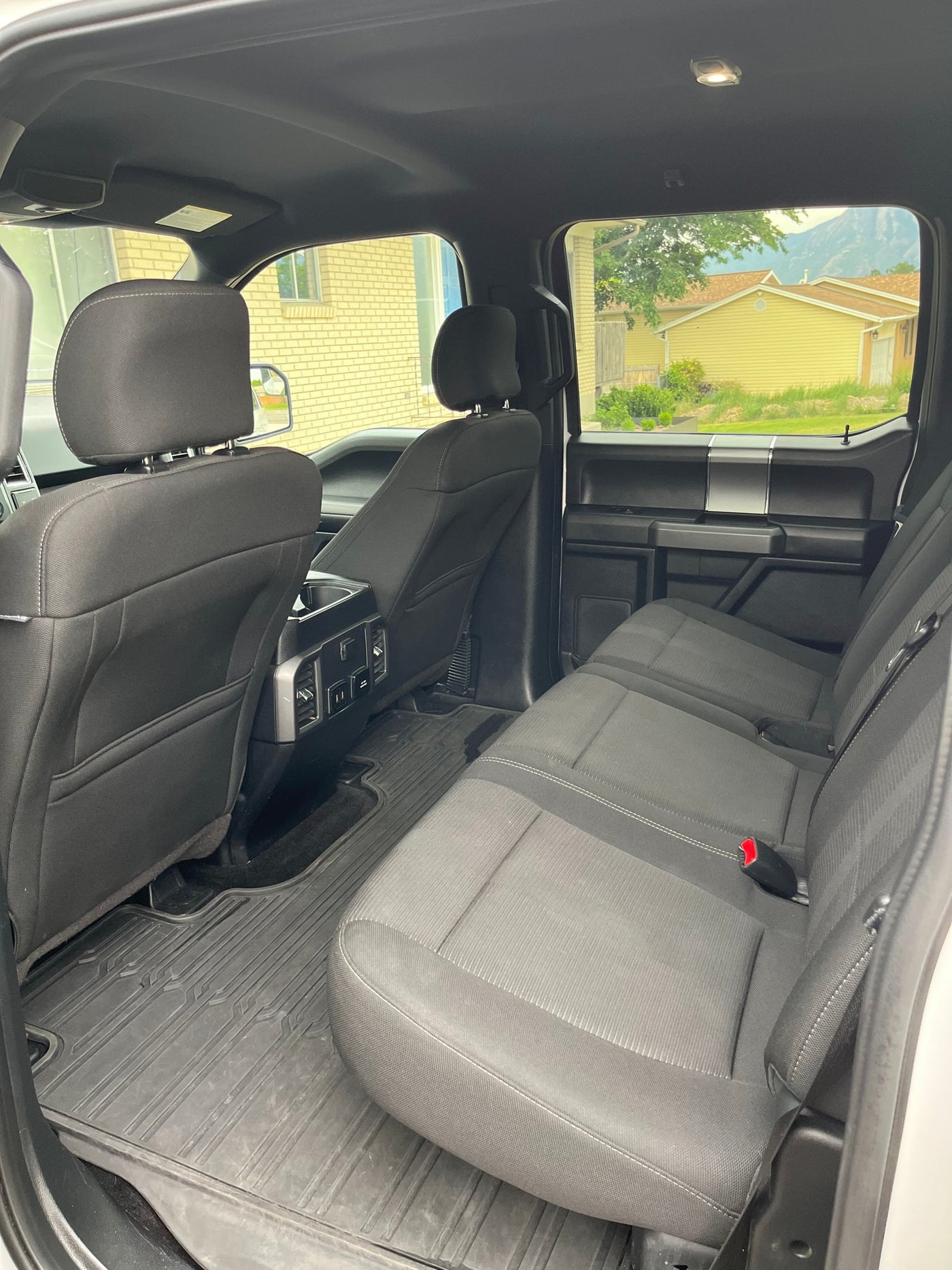 Spacious truck interior with comfortable seats & durable floor mats. Perfect for travel, complementing your RV rental search. — photo 15
