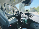 Bright RV rental van interior: dashboard, passenger seat, and two travel mugs. A clean, spacious cabin ready for travel.