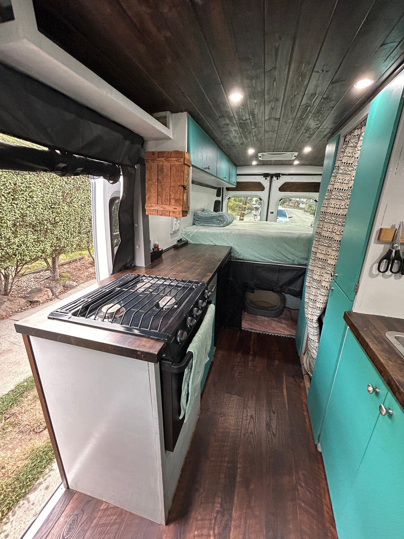  perfect for a road trip adventure.|Cozy RV rental interior with a built-in kitchen — photo 1