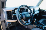 Modern Ford Bronco interior features steering wheel & digital dash. Perfect for a comfortable rv rental experience.
