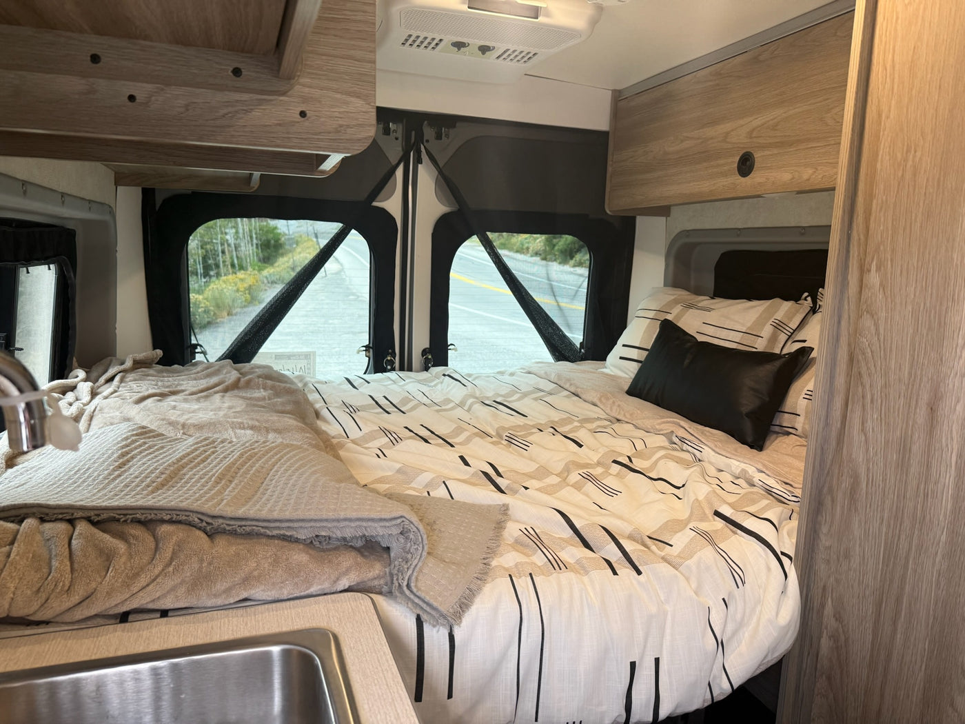  perfect for adventure and off-grid camping.|This silver camper van rv rental is parked in golden light — photo 7