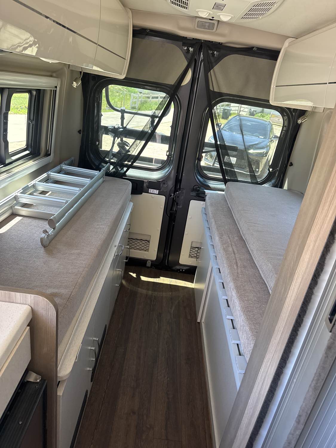  perfect for travel.|Step inside this RV rental! Features a compact kitchen with a stainless steel sink — photo 2