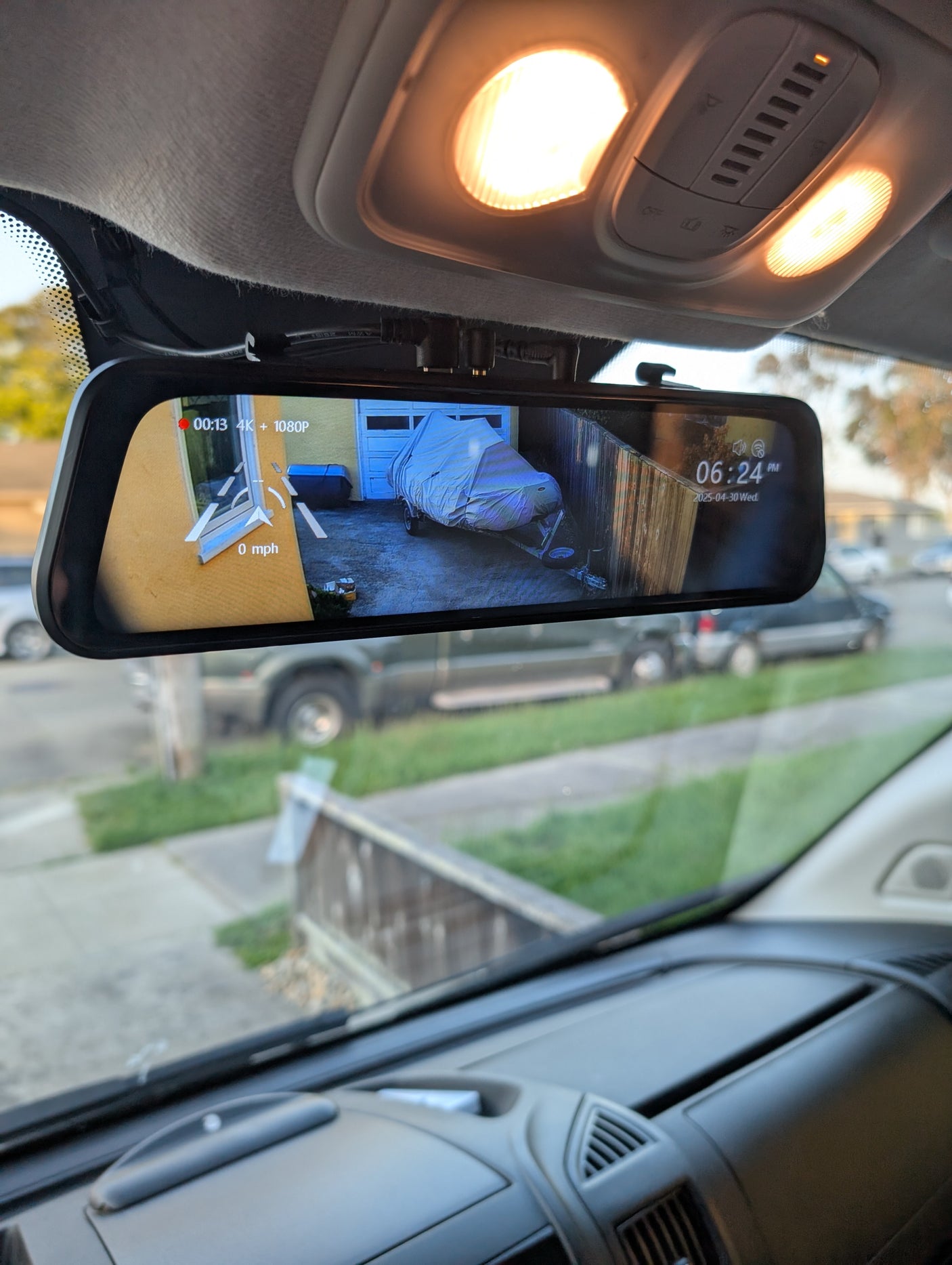 RV rental interior: Digital rearview mirror shows live rear camera feed with recording data (4K+1080P), time, and date.