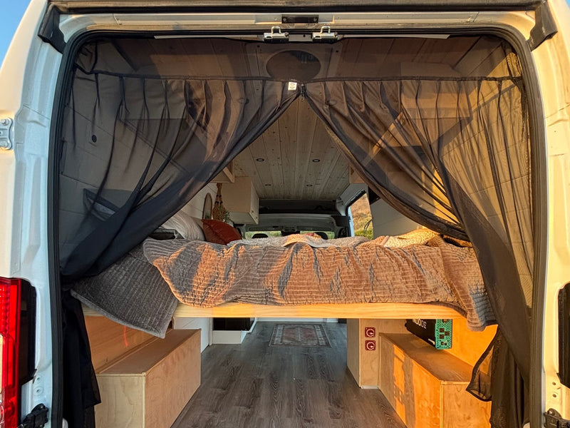  and a stunning window view for your next adventure.|Cozy RV rental interior with bed overlooking the ocean — photo 4