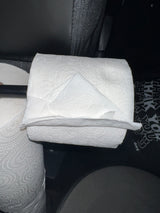 Neatly pointed toilet paper roll on a holder, a thoughtful amenity in an RV rental bathroom.