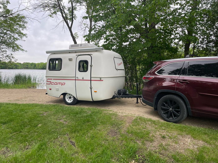  a family of four enjoys a meal at the dinette next to a compact kitchen.|Step inside this RV rental's cozy kitchen area