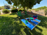 Camping setup with SUV, roof-top tent, chairs, and table on grass. Great for an RV rental trip.