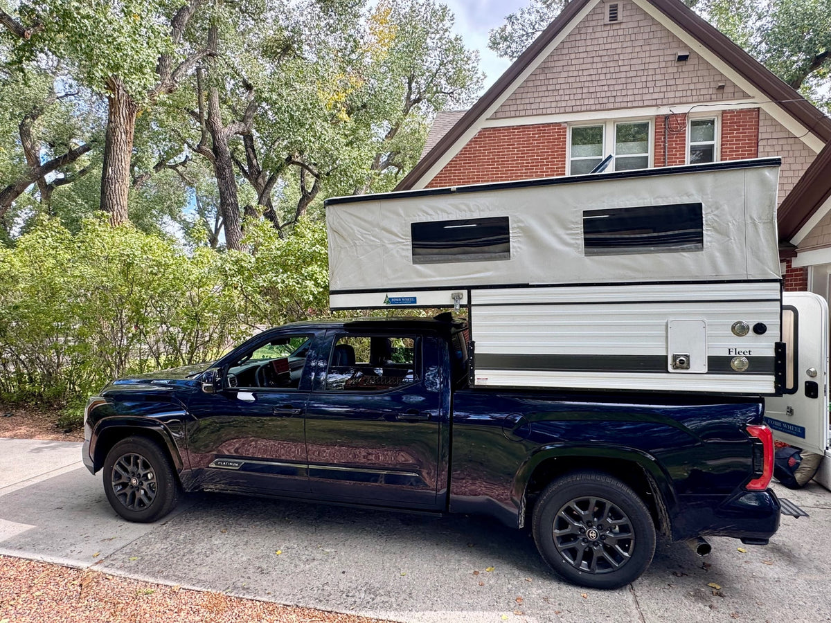  and storage. Ideal for road trips!|RV rental interior: a pop-up camper's organized sleeping and seating area with bright lights & window views.|RV rental interior: a spacious sleeping area with a ceiling fan — photo 14
