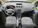 Ford Transit Connect van interior: dashboard, steering wheel, front seats, and automatic transmission. Ideal for an RV rental or work vehicle.