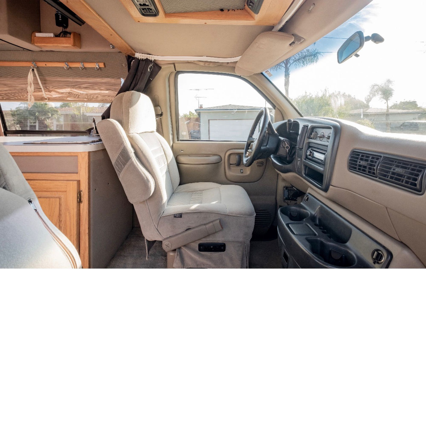  and wood cabinets.|Cozy rv rental interior with a comfortable bed — photo 7