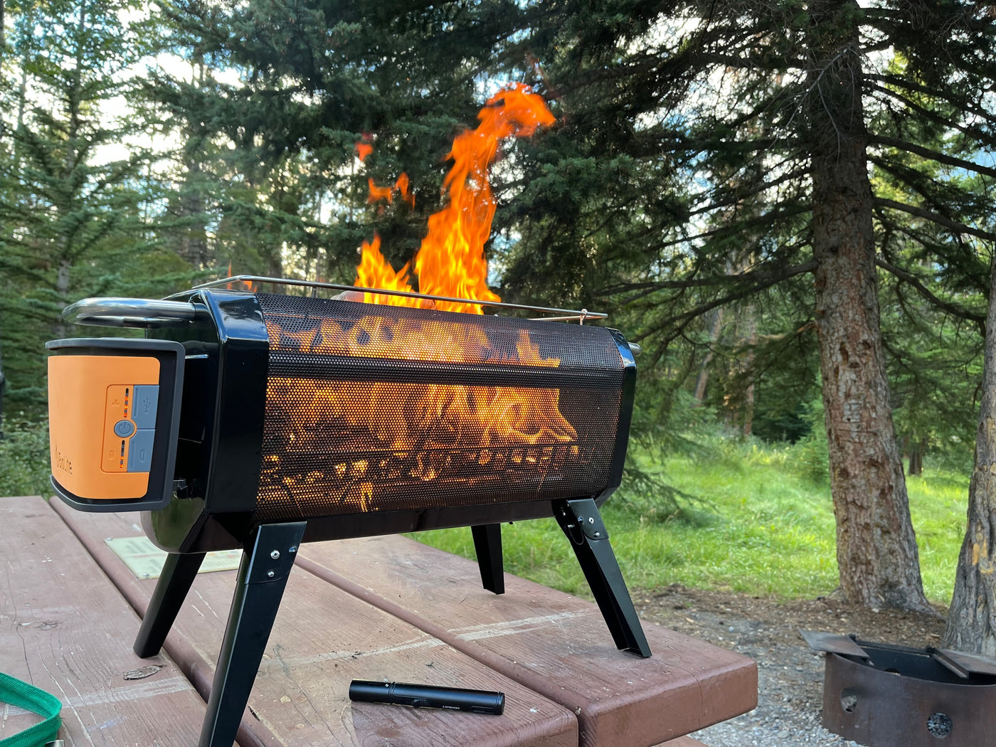 Bright flames from a BioLite portable fire pit at an RV rental campsite. Outdoor warmth & ambiance. — photo 10