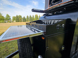 Black OTG camper trailer with pull-out solar panel & rooftop tent for your next RV rental adventure.