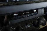 RV rental van's dashboard: Climate control panel displaying LO temperature and fan speed 5, with cup holders and wood trim.