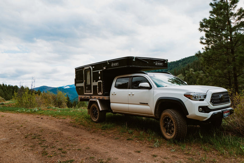  perfect rv rental for snowy forest adventures.|Explore Idaho's mountains with this white Toyota Tacoma & truck camper. Perfect for your next RV rental overlanding adventure. — photo 13