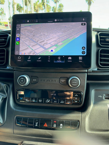 Inside a Ram RV rental: Modern dashboard with a large Uconnect infotainment screen showing Google Maps, CarPlay, and climate controls.