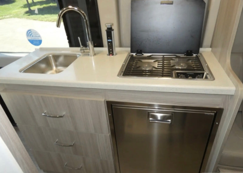  and a picturesque lake view from your cozy camper.|A sleek gray rv rental camper van — photo 2