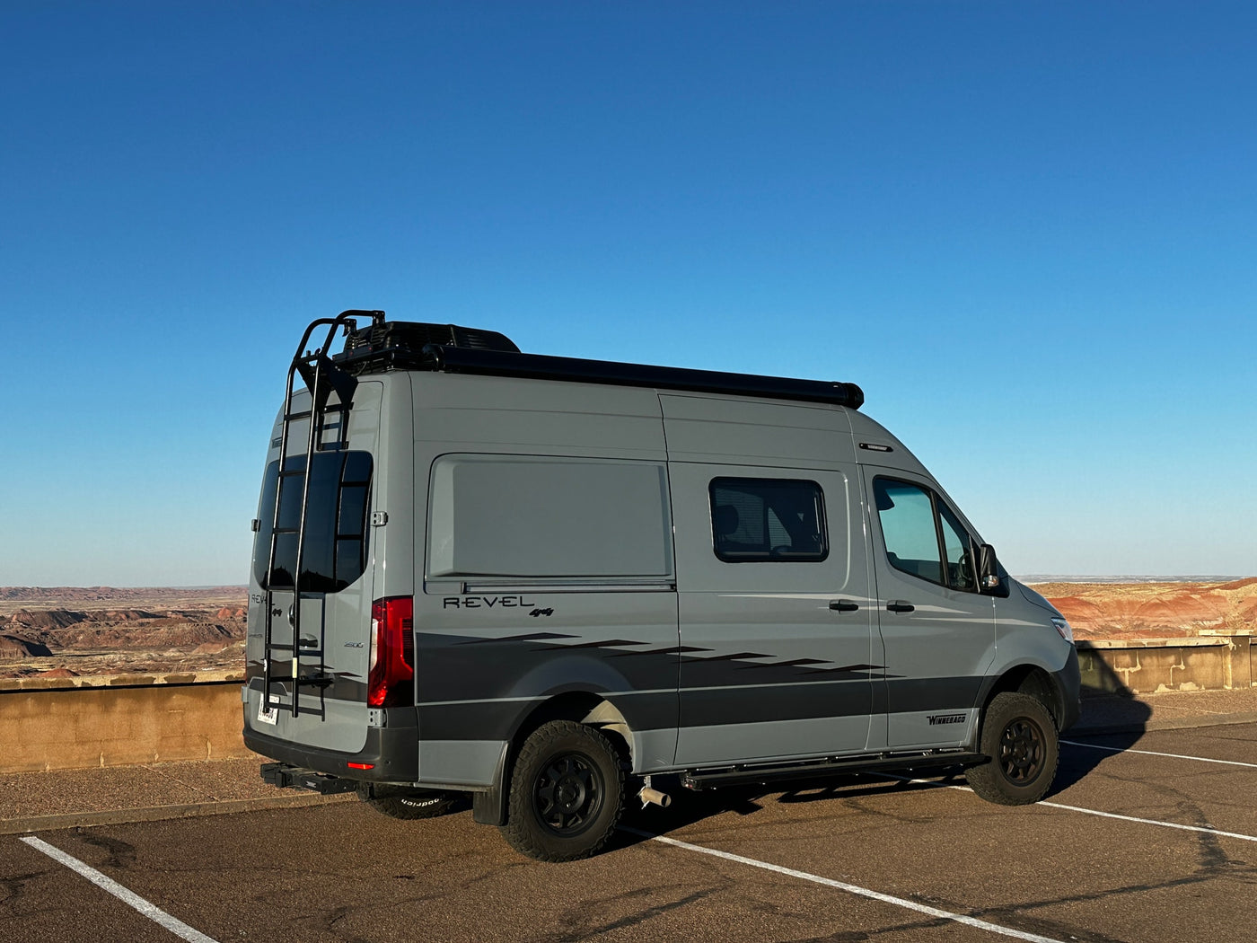 Exploring with an RV rental: a gray Winnebago Revel camper van parked at a scenic desert overlook. — photo 5