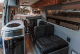 Modern RV rental interior with kitchen, elevated bed, passenger seating, & secure bike storage. Explore in comfort.