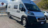 A white Winnebago camper van, built on a Ram ProMaster chassis, ideal for RV rental, parked outdoors on a sunny day.