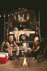 Cozy night with our RV rental, roasting s'mores by the campfire. Our bulldog enjoys the van life adventure!